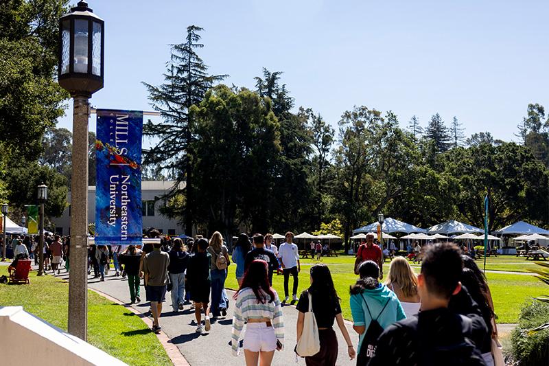 Students walk along path in front of Suzanne Adams Plaza