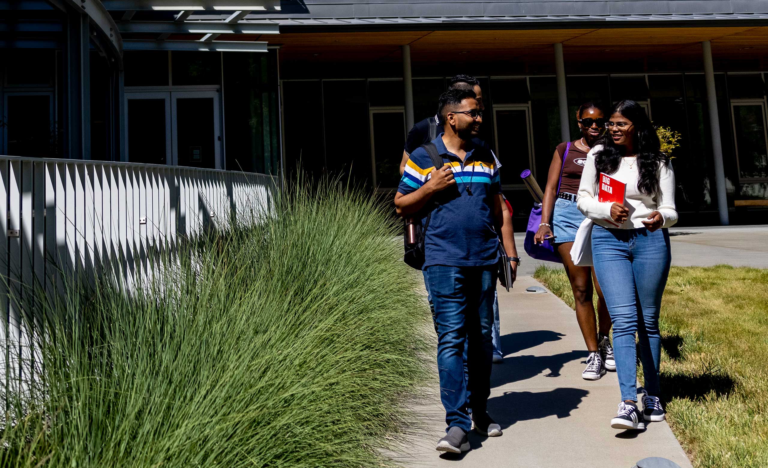 A group of students leaves the Lorry I. Lokey Graduate School of Business and Public Policy on Northeastern University's Oakland campus.